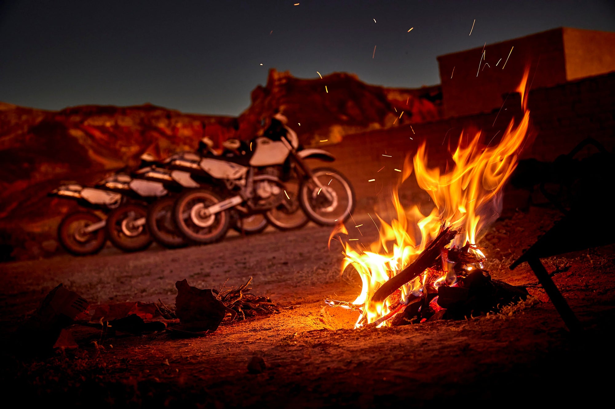 DR650 lit by campfire
