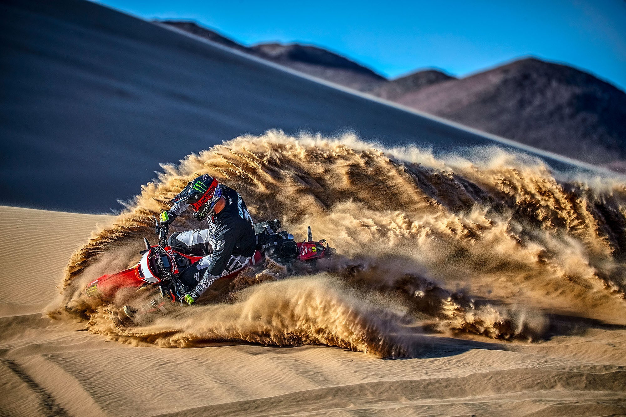 Motorcycle rider roosting in the sand dunes